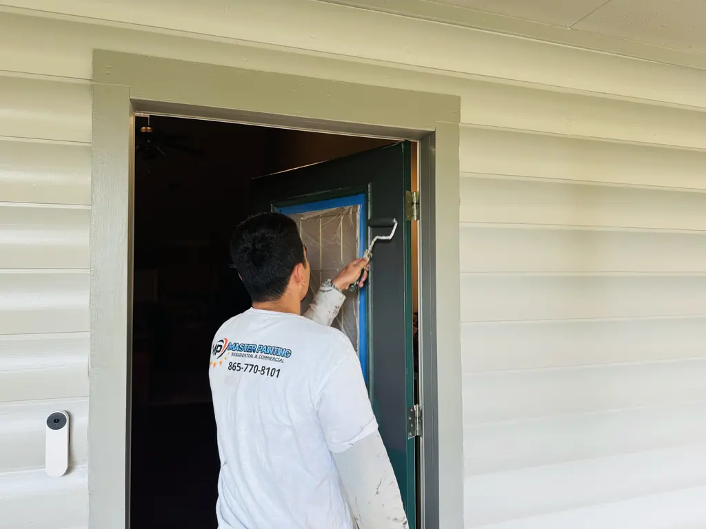 Master Painting painter working on an entry door and its trim
