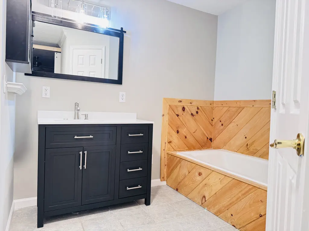 Bathroom walls painted around a navy vanity